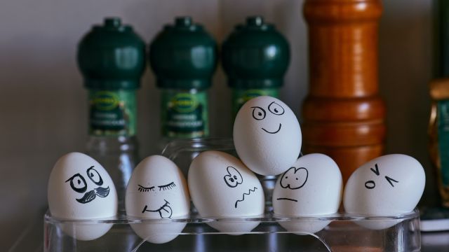 white and black eggs on glass rack